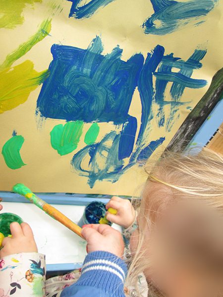 A child painting at the easel