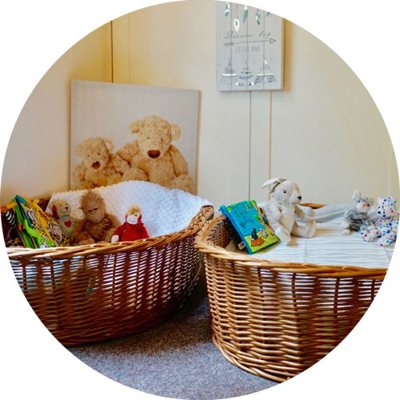Baby room with wicker baskets, teddies and soft books
